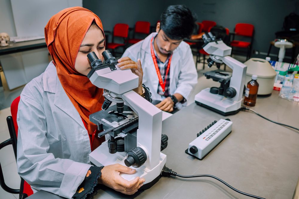 Students conducting a microscope experiment in the science lab