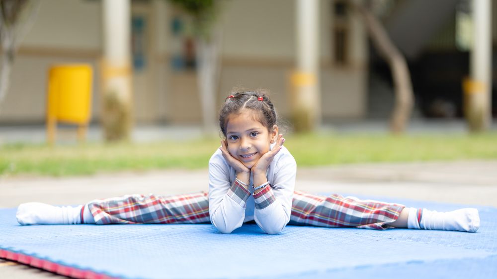 A student practising yoga outdoors
