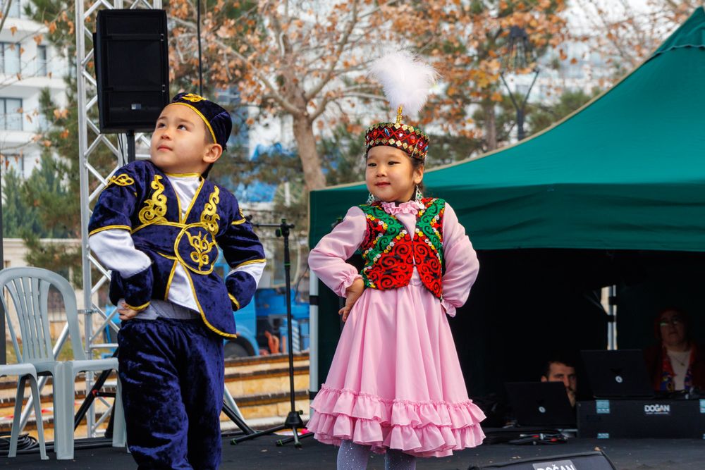 Children in traditional dress performing on stage